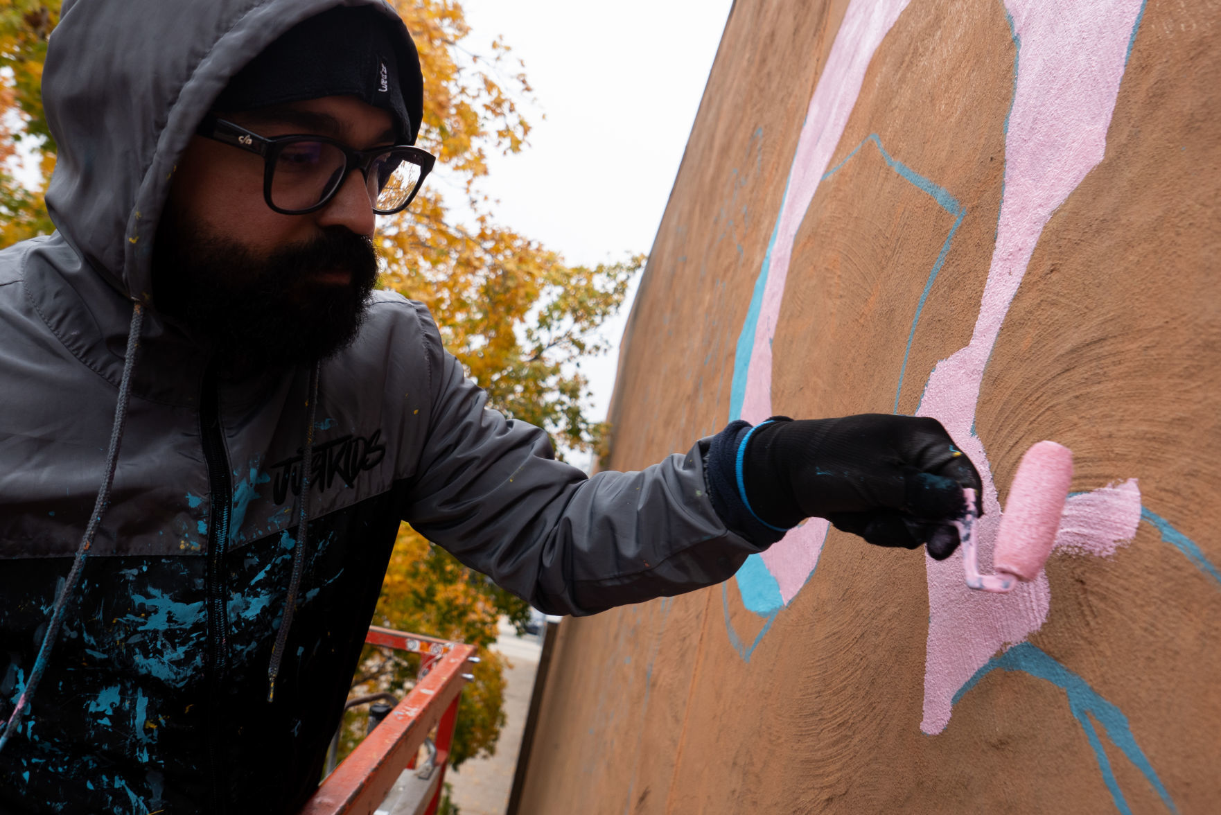 Renato Reno paints the mural at AJ's NY Pizzeria